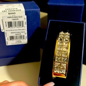 Swarovski gold tone bangle.